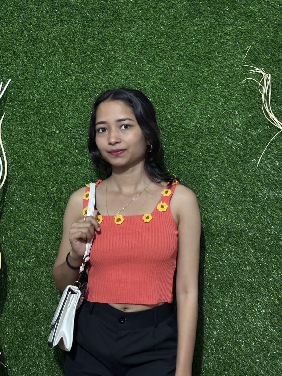 Reddish-orange tank top with sunflower details on the straps, perfect for casual summer wear.